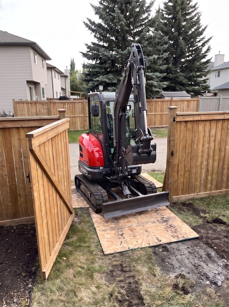 Compact excavator passing through a backyard gate opening with centimetres to spare